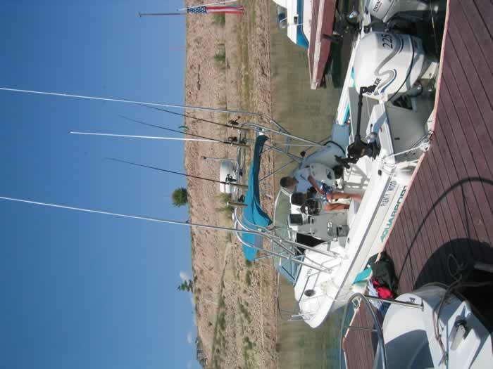 Atlantic Towers Arch installed on an Aquasport 215 Explorer walkaround boat shown from the side on water.