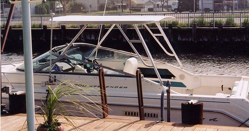 Atlantic Towers Top installed on a Sea Ray 300 Weekender boat at a dock beside a calm waterway.