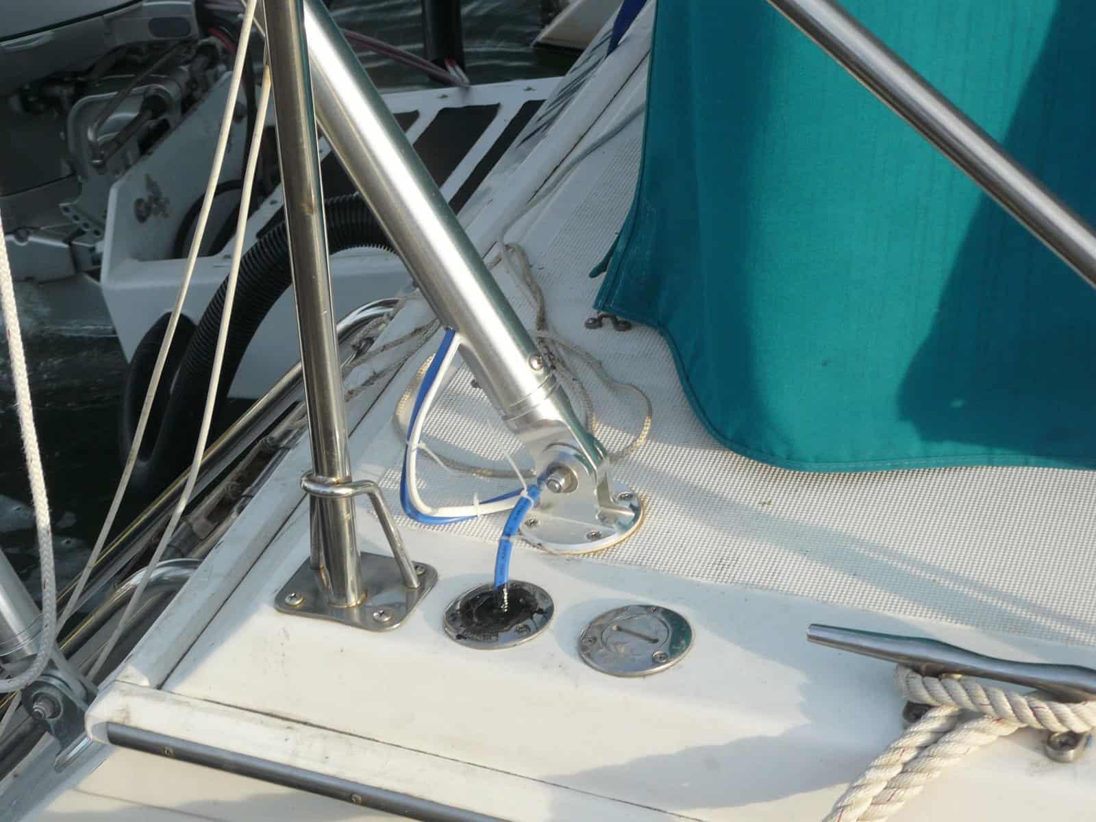 Close-up of Atlantic Towers Arch installed on an Endeavour boat's deck, showing metal fittings, ropes, and a blue canvas cover.