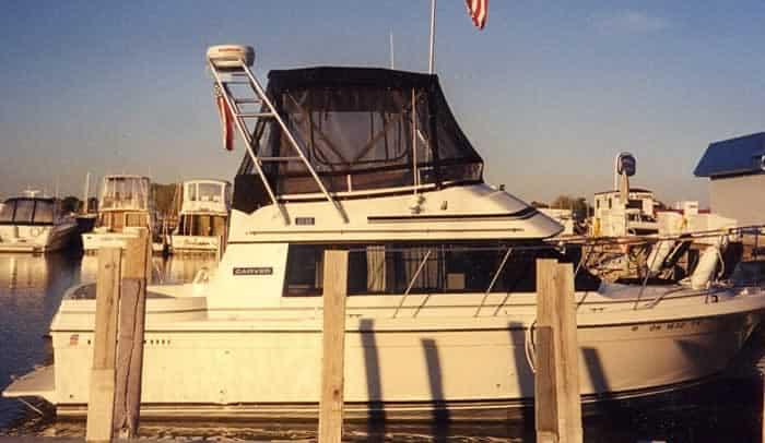 Atlantic Towers Arch installed on a Carver Mariner boat docked at a marina, surrounded by other boats.