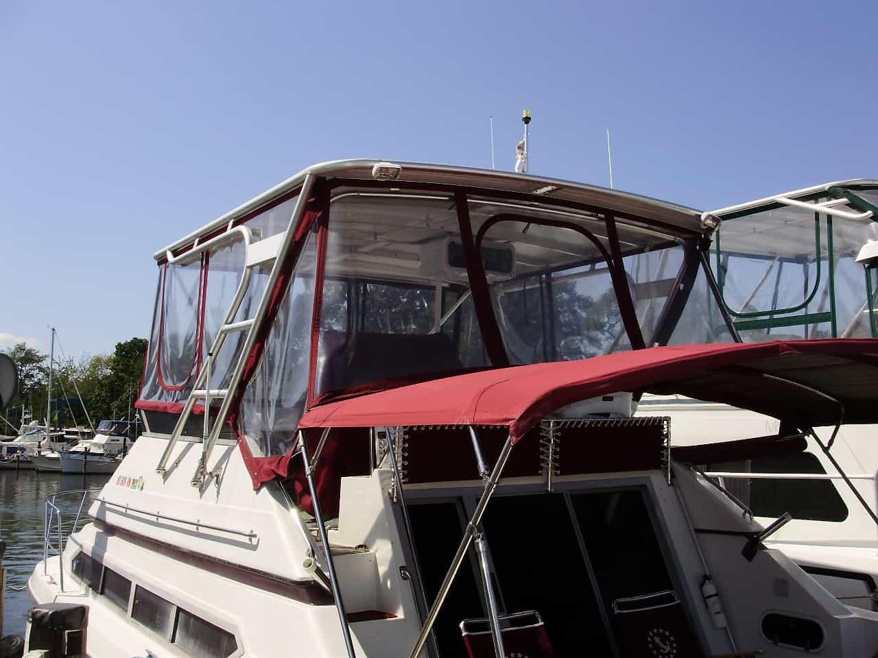 Carver 34/638/380 Santego boat with Atlantic Towers Top installed, featuring red canvas and clear windows on the upper deck.