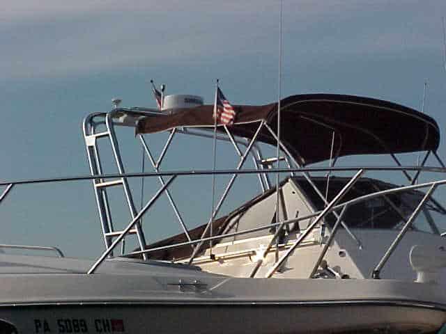 Atlantic Towers Arch installed on a Carver 2896 Mariner boat with a canopy and flags displayed.