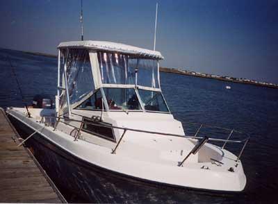 Atlantic Towers Top installed on Grady White 20 Overnighter walkaround boat docked at a marina with calm water.