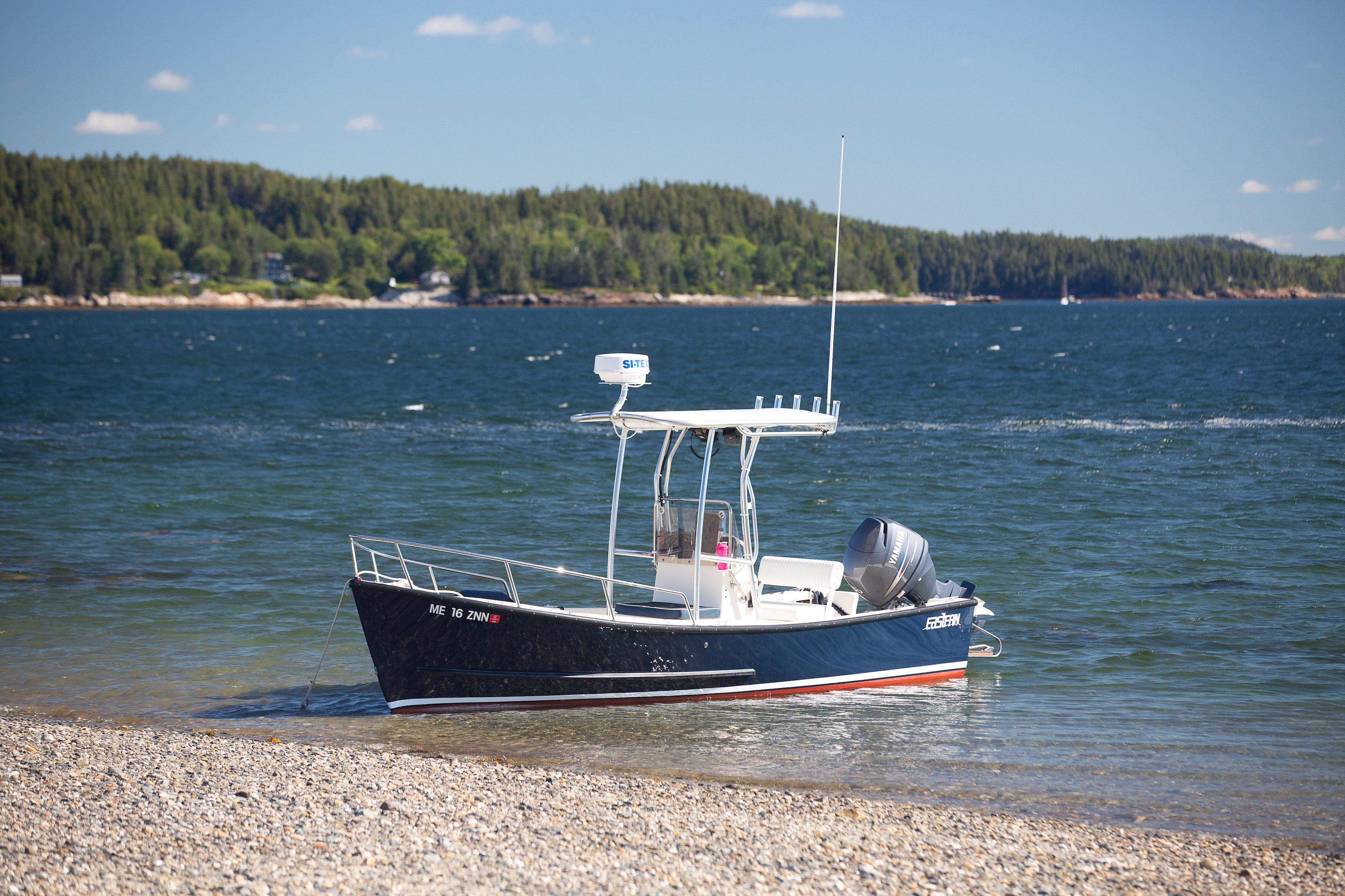 Atlantic Towers T-Top installed on an Eastern Boats vessel anchored near a rocky shoreline and blue water.