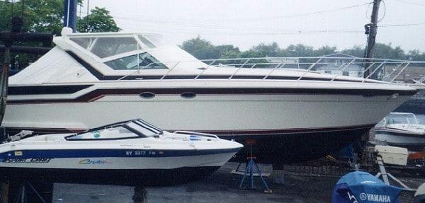 Atlantic Towers Top installed on Wellcraft 43 Portofino boat docked on land beside smaller boat and equipment.
