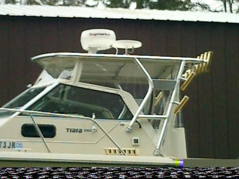 Side view of a Pursuit 2600 Tiara boat with an installed Atlantic Towers top and fishing rod holders mounted on the tower.