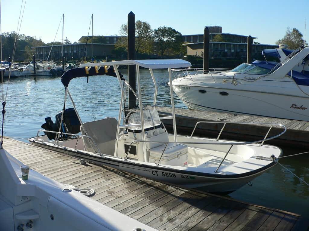 Boston Whaler 17 Center Console boat docked with Atlantic Towers T-Top installed on a sunny day at the marina