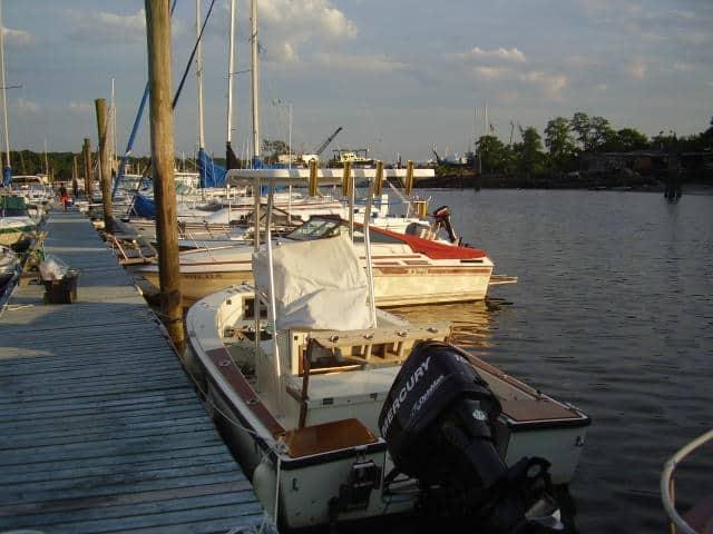 Atlantic Towers T-Top installed on a Sea Craft 19 boat docked at a marina with other vessels in the background.