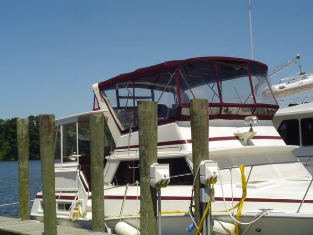 Atlantic Towers Top installed on a Viking 43 DC Motoryacht docked near wooden posts by the water.