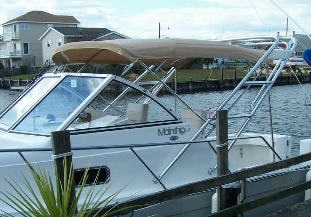 Atlantic Towers Arch installed on a Mainship 30 Pilot cruiser boat showing side and rear views on water.