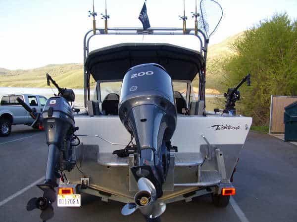 Atlantic Towers Arch installed on a Weldcraft 201 Maverick boat, showcasing dual outboard motors in a lakeside setting.