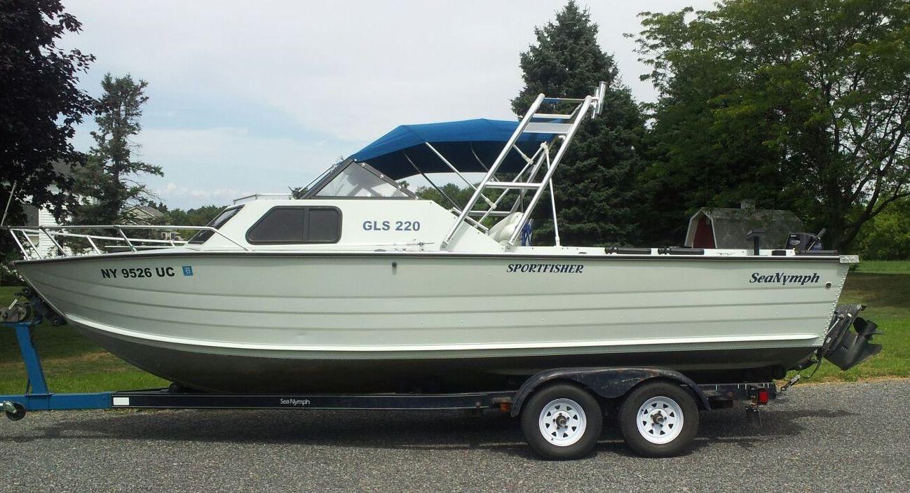 Sea Nymph boat on a trailer with a blue canopy and installed Atlantic Towers Arch near the cockpit area
