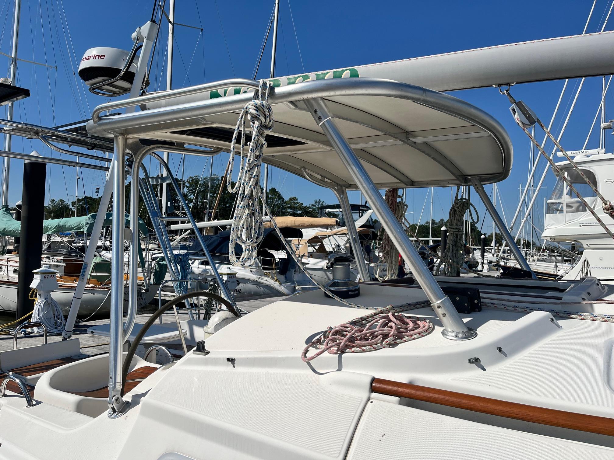 Atlantic Towers Top installed on a Jeanneau sailboat, showing a stainless steel frame and canvas roof over the helm.
