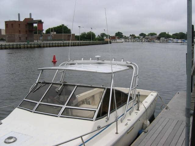 Atlantic Towers Top installed on a Phoenix 27 Weekender boat, moored in a calm waterway.