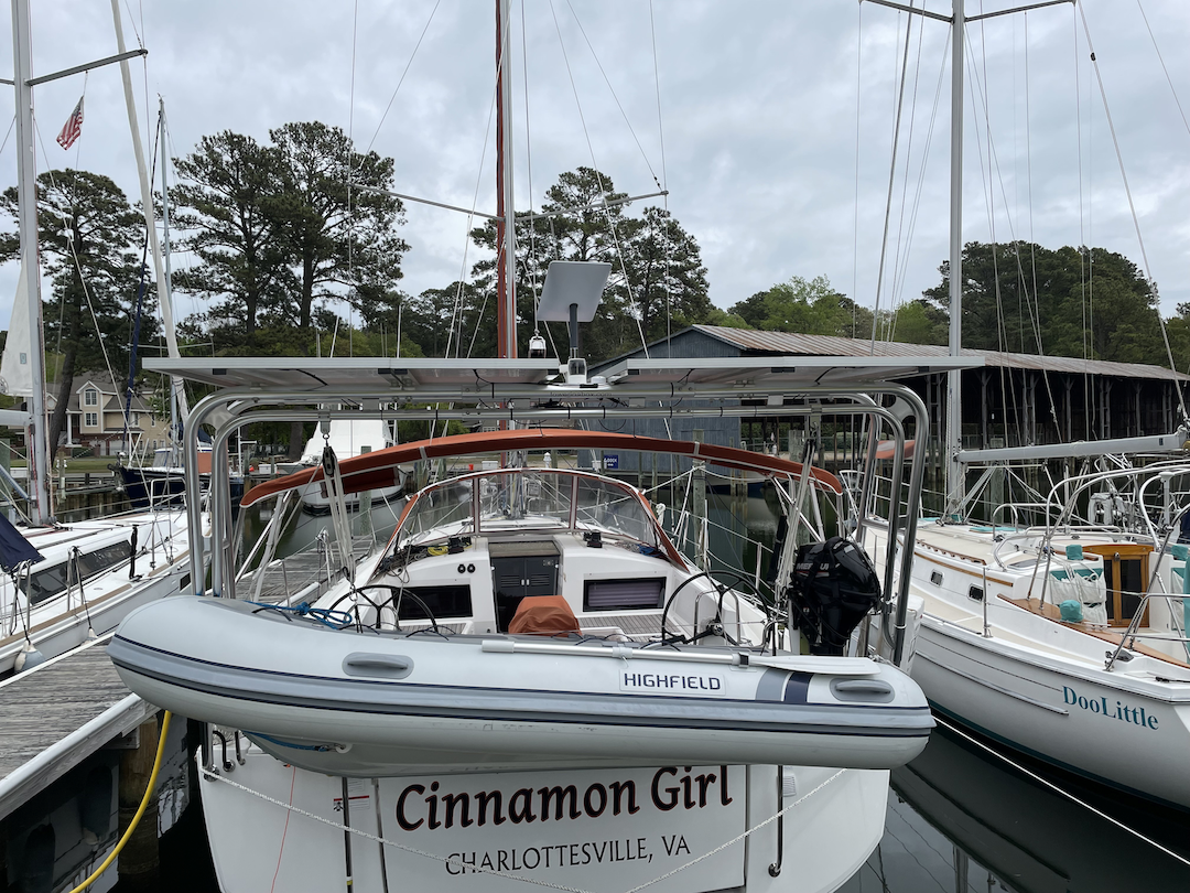 Atlantic Towers Arch installed on a Jeanneau boat named "Cinnamon Girl" at a marina, with a dock and other boats in view.