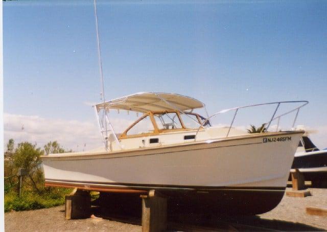 Atlantic Towers Top installed on a Fortier Boats 26 Cuddy, displayed on blocks under a sunny sky.