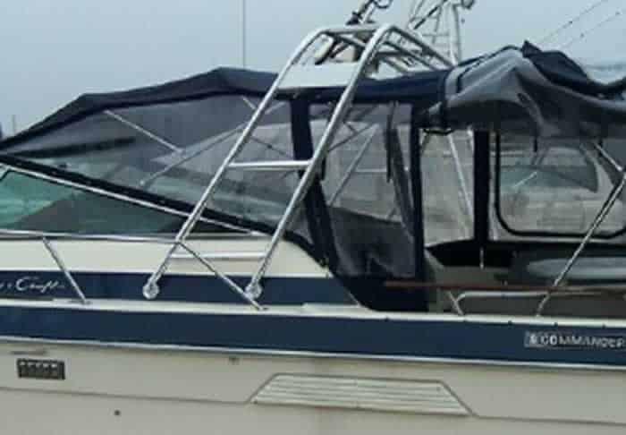 Side view of a Chris Craft 336 Commander boat with an installed Atlantic Towers arch and a black canvas cover over the cockpit area.