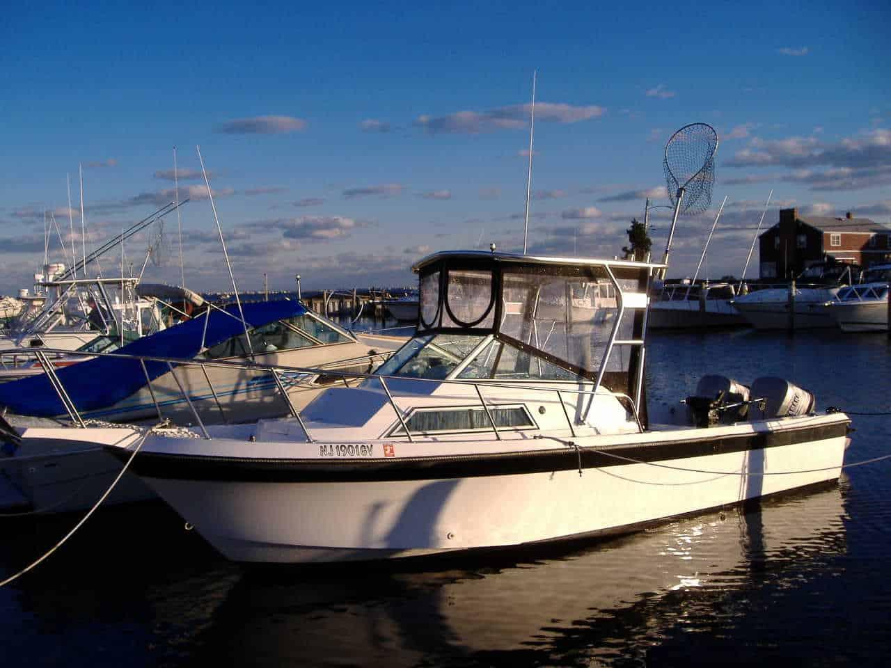 Atlantic Towers Top installed on a Wellcraft 250 Coastal boat moored at a marina, surrounded by other boats.