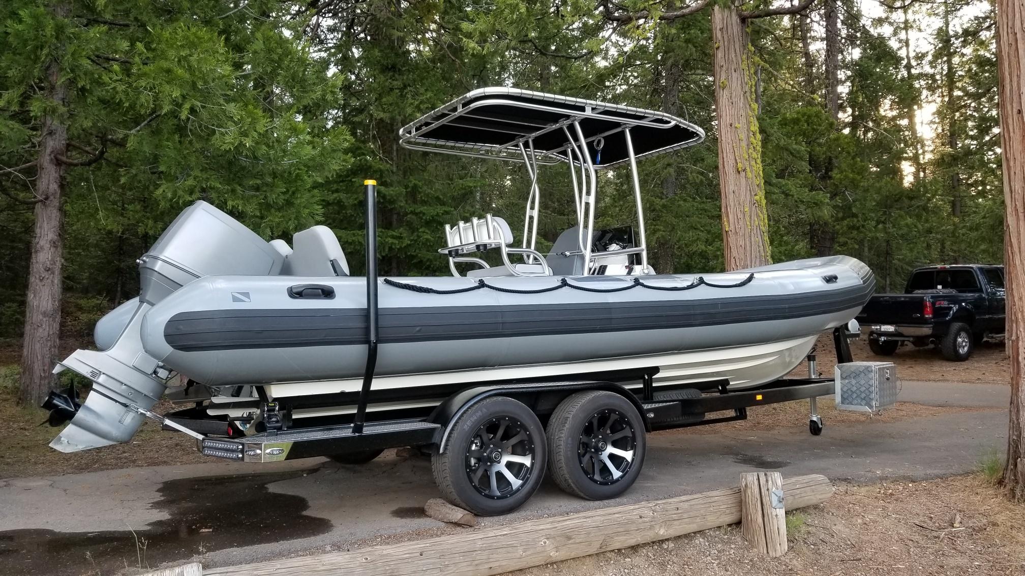 Atlantic Towers T-Top installed on an AB Inflatables boat, parked on a trailer in a forested area.