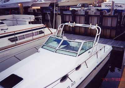 Atlantic Towers arch installed on Stamas 255 Riviera boat docked at a marina with other boats nearby.
