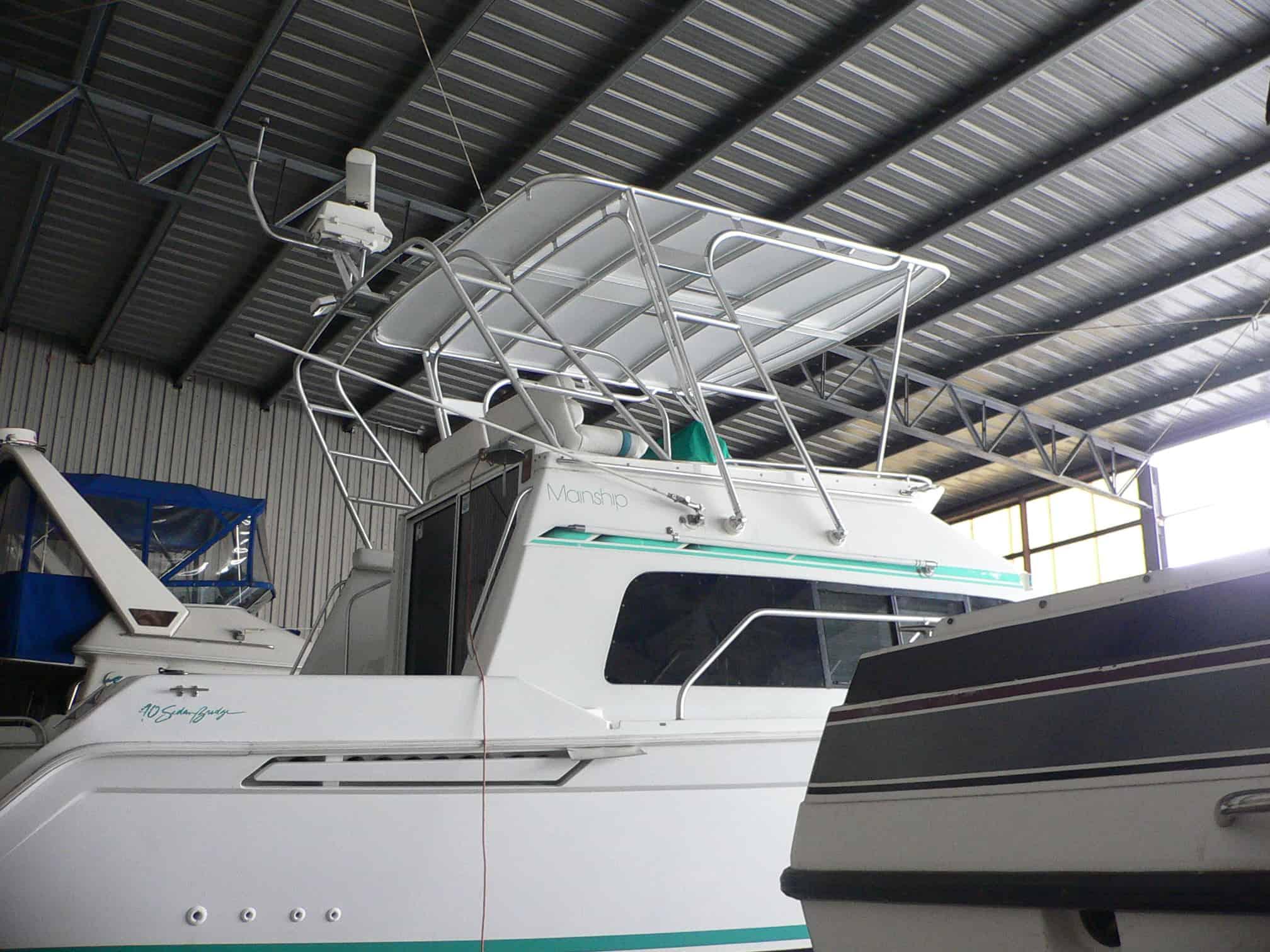 Mainship 40 Sedan Bridge yacht with Atlantic Towers Top installed under a covered storage area.