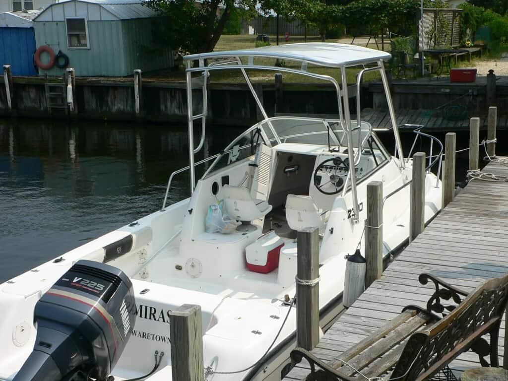 Atlantic Towers Top installed on a Century 2300 walkaround boat docked near a wooden pier.