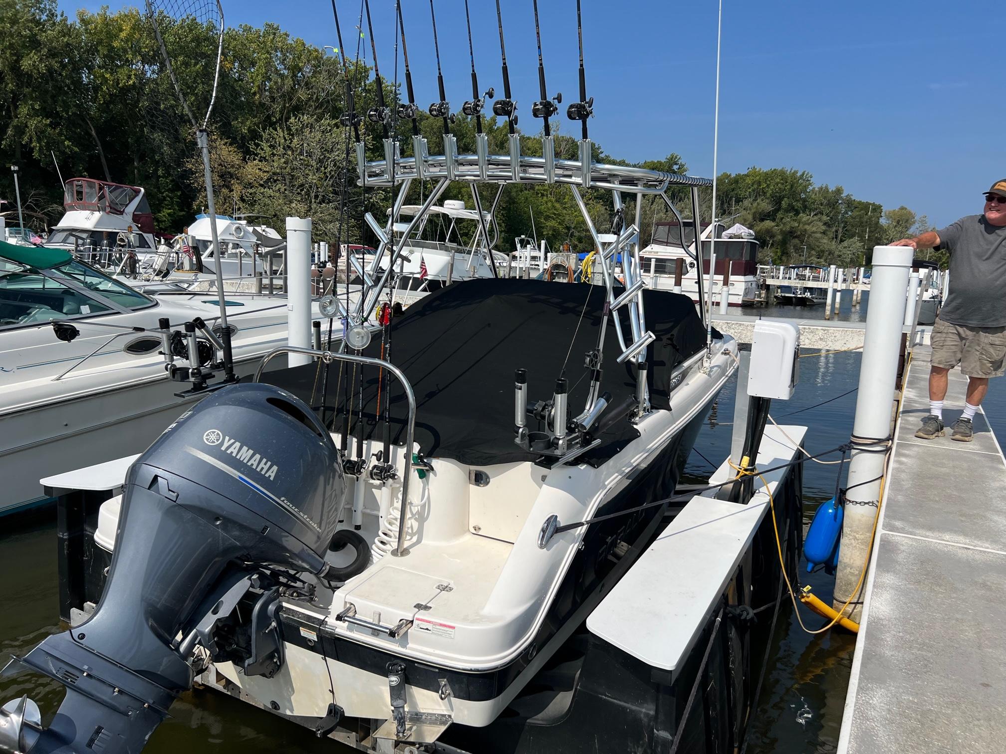 Atlantic Towers Top installed on a Robalo Dual Console boat with fishing rods docked in a marina.