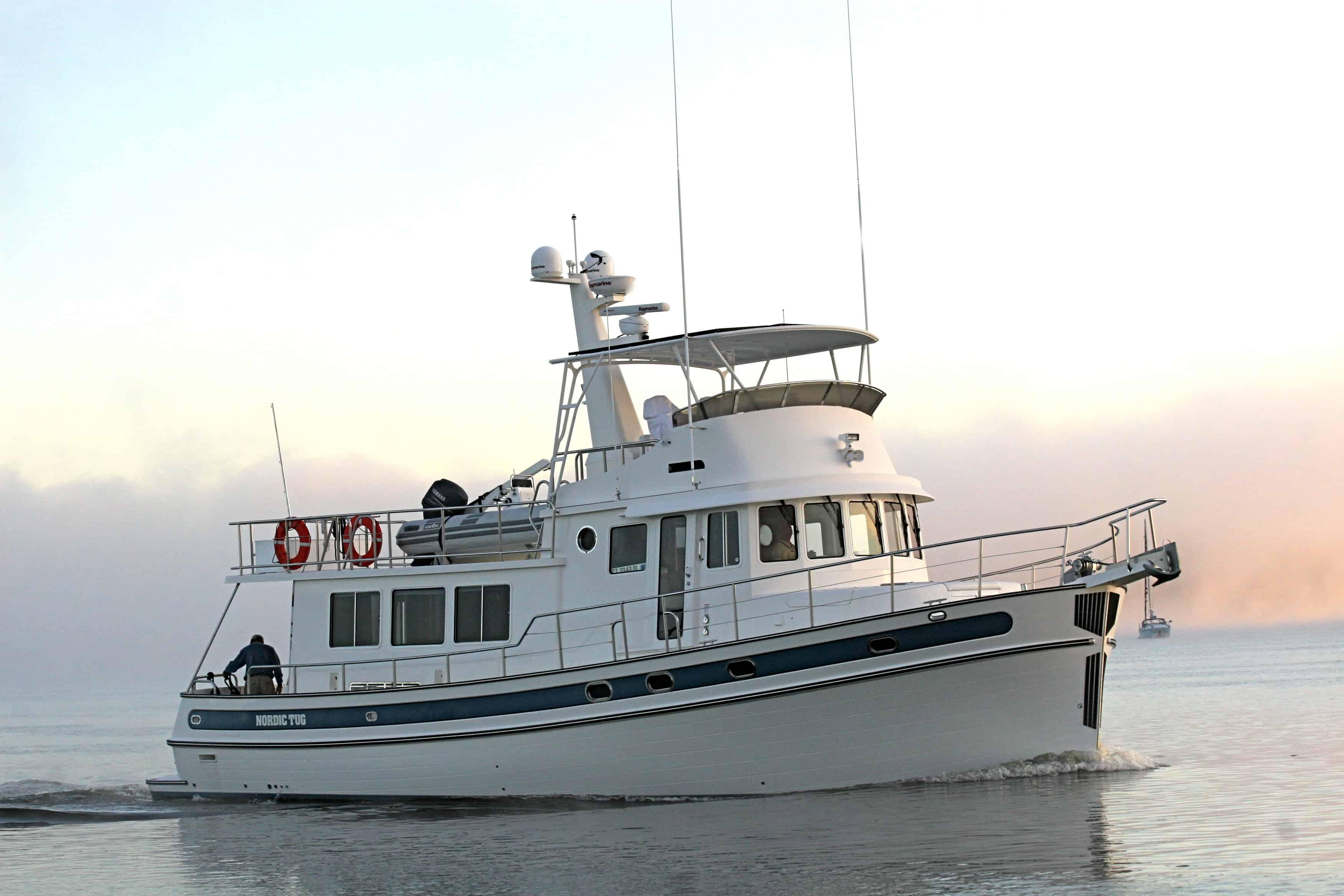 Nordic Tugs 54 boat cruising in calm water with Atlantic Towers Top tower and radar equipment visible.