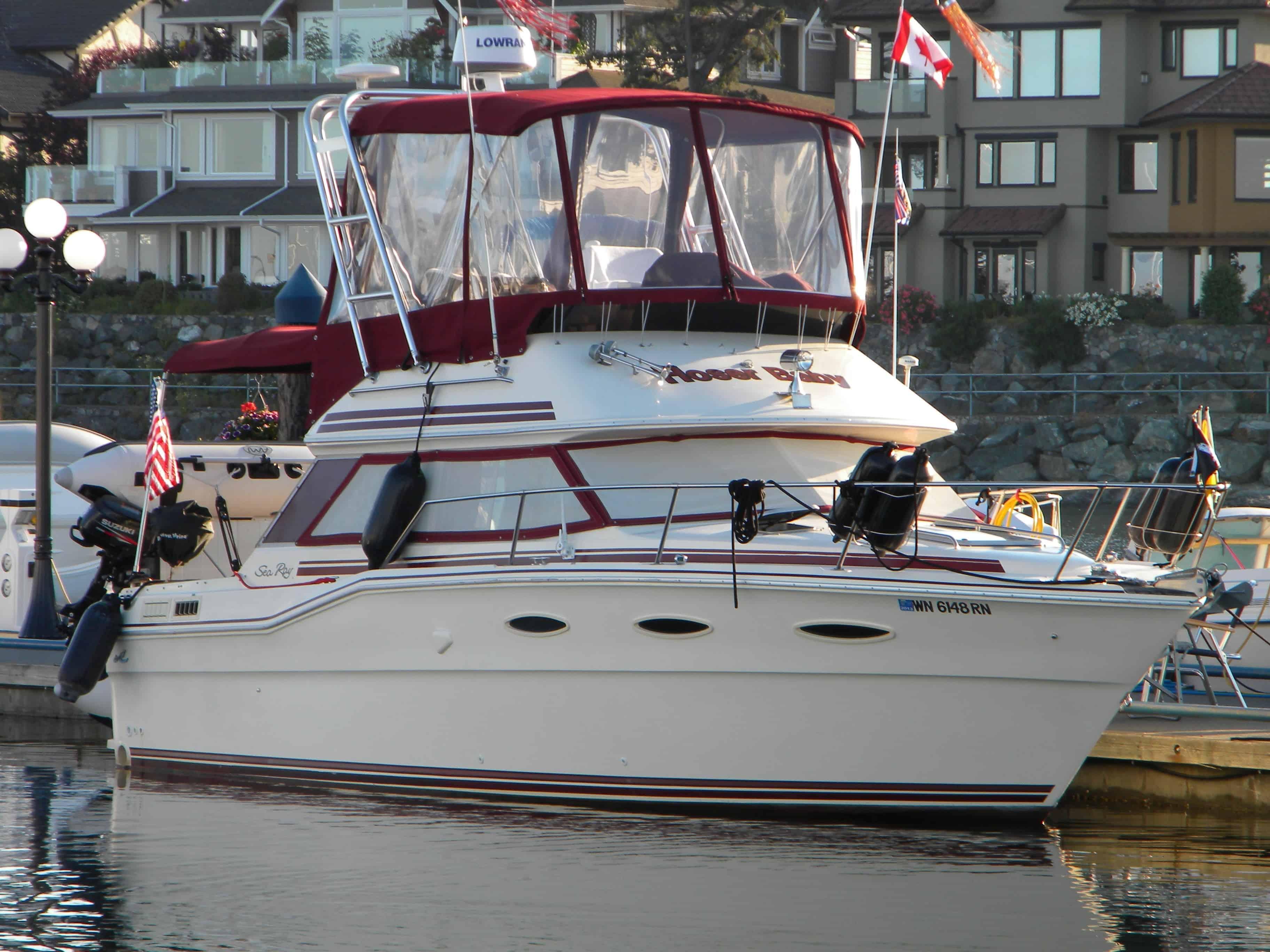 Atlantic Towers Arch installed on a Sea Ray 300 sedan boat shown docked in a marina with other boats nearby.