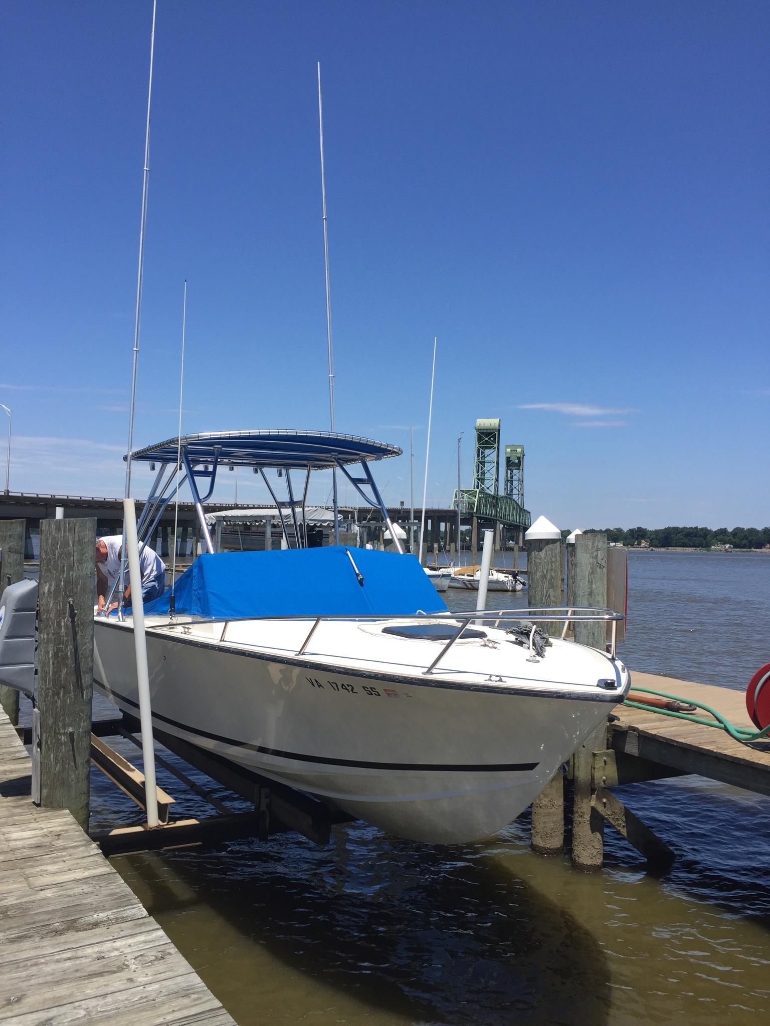 Atlantic Towers Top installed on an Albemarle boat at a dock on a sunny day, with blue sky and water.
