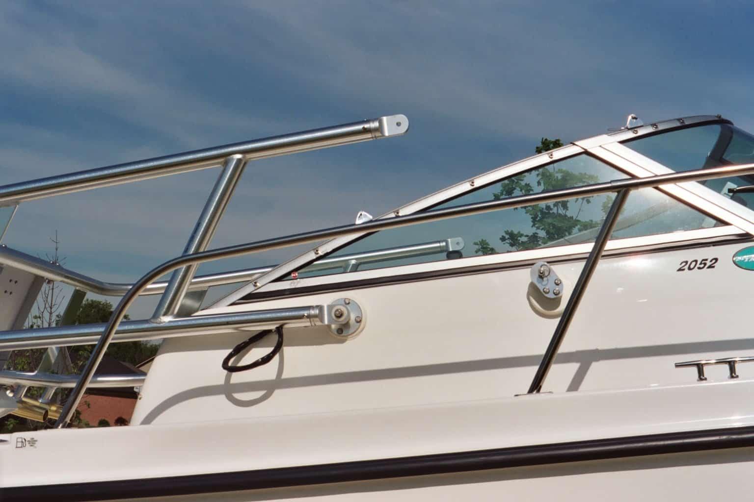 Close-up of a stainless steel Atlantic Towers Arch installed on the side of a 2152 Trophy boat under a partly cloudy sky.