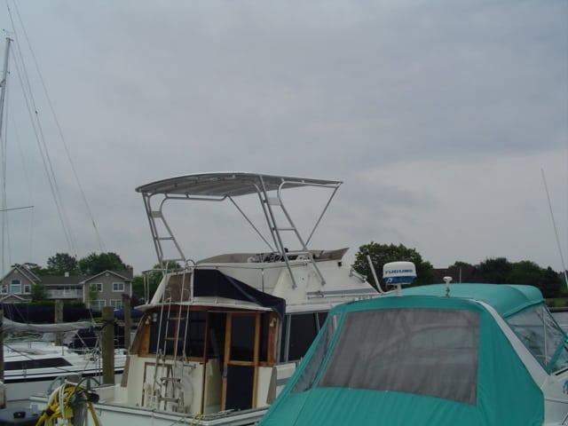 Bayliner 3888 MY boat docked with an installed Atlantic Towers Top providing overhead shade on the flybridge.