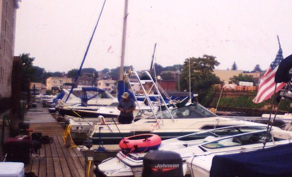 Atlantic Towers arch installed on a Sea Ray 250 Sundancer boat at a marina, with several boats visible in the background.