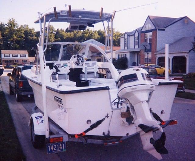 Maritime Skiff boat with an Atlantic Towers Top installed, mounted on a trailer in a residential neighborhood.