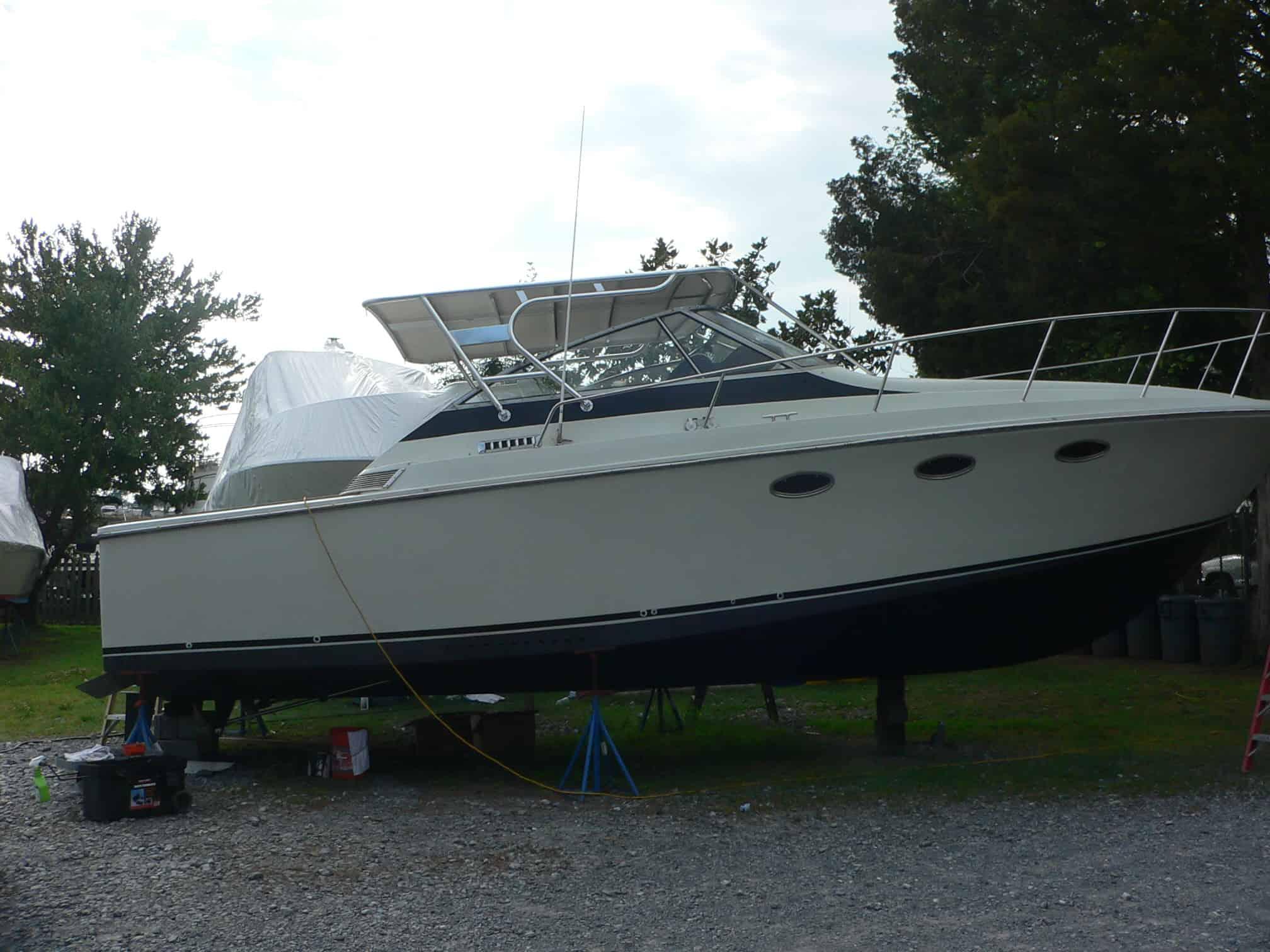 Trojan 10 Meter Express boat on dry land equipped with Atlantic Towers Top frame and canvas canopy system