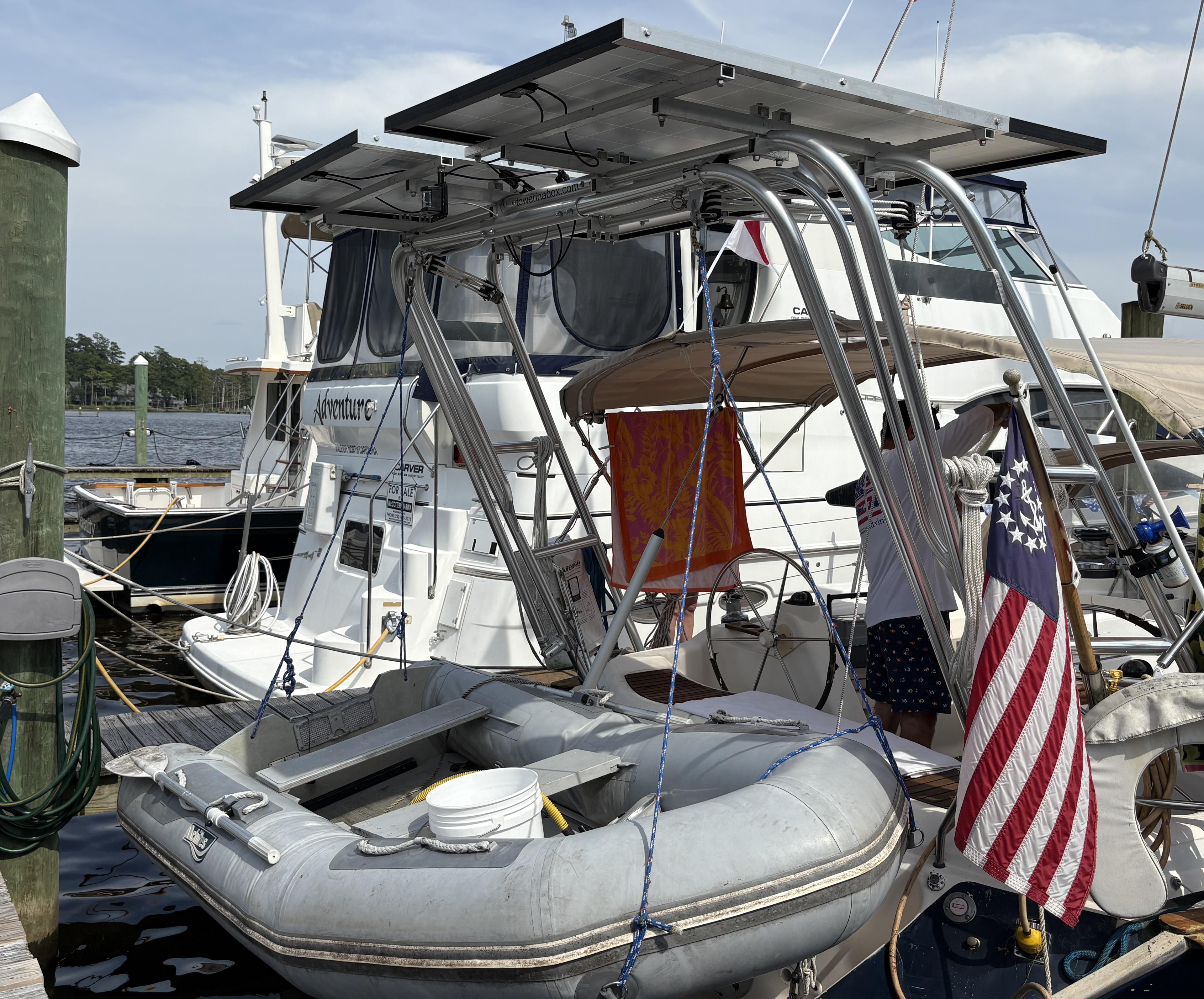 Atlantic Towers Arch installed on a boat with a dinghy, displaying an American flag and surrounded by other vessels.