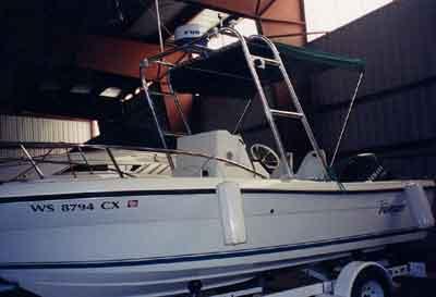 Atlantic Towers Arch installed on Pursuit 1950 Console boat inside a storage facility on a trailer.