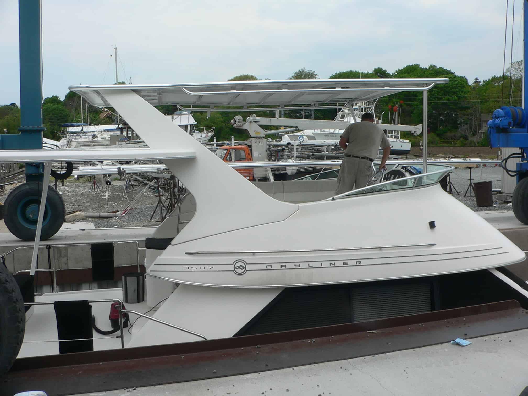 Atlantic Towers Top installed on a Bayliner 3587 Motor Yacht at a marina, with a person working nearby.