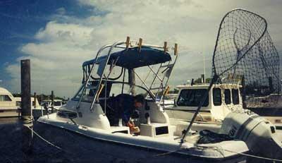 Atlantic Towers arch installed on a Stratos 2160 Walkaround boat docked at a marina under partly cloudy sky.