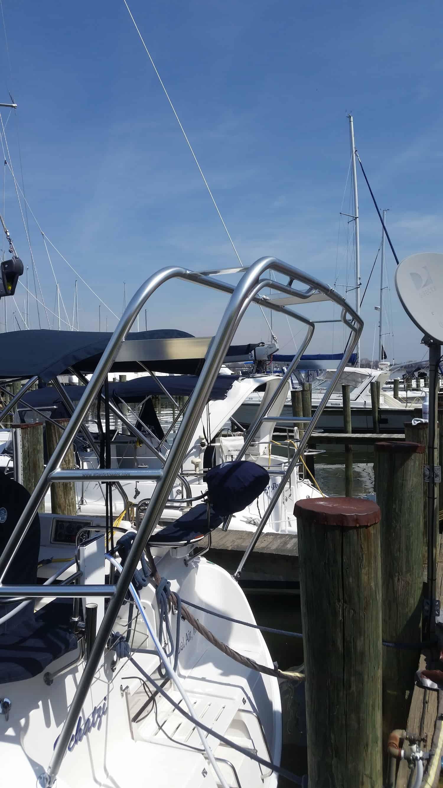 Atlantic Towers Arch stainless steel installed on the back of a Catalina sailboat docked at marina with other boats nearby