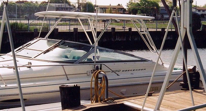 Sea Ray 300 Weekender boat docked with installed Atlantic Towers Top providing shade over the cockpit area.