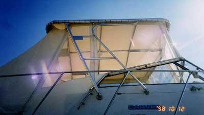 Atlantic Towers Top installed on a Carver 32/330 Mariner, showcasing a canopy structure against a bright sky.