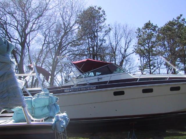 Atlantic Towers arch installed on a Wellcraft 3100 Montego boat, surrounded by trees and covered items.