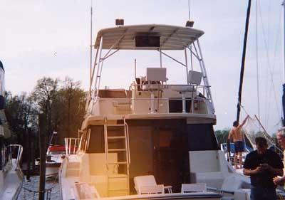 Atlantic Towers Top installed on Silverton 37 Convertible boat docked with people nearby during daytime