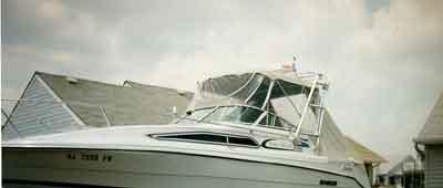 Atlantic Towers Arch installed on a Rinker 260/265 Fiesta Vee boat, featuring a sleek design against a cloudy sky.