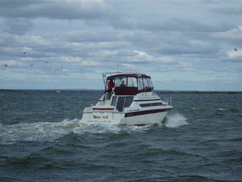 Atlantic Towers Arch on a Carver 34/638/380 Santego boat cruising in open water under a cloudy sky.