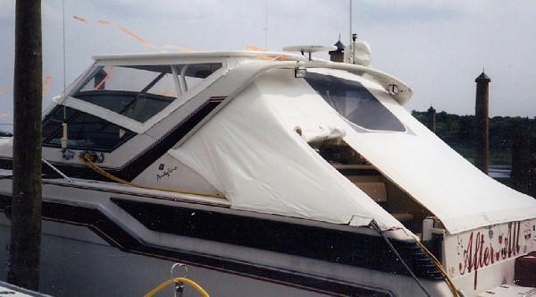 Atlantic Towers Top installed on a Wellcraft 43 Portofino boat, featuring a white canopy and front windshield.