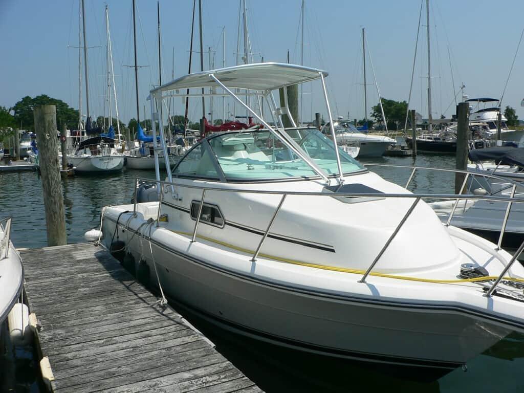 Stamas 270 Express boat featuring Atlantic Towers Top, docked with other boats in the marina.