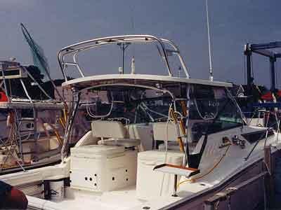 Atlantic Towers Arch installed on the cockpit area of a Wellcraft 330 Coastal boat docked at a marina with nearby vessels.