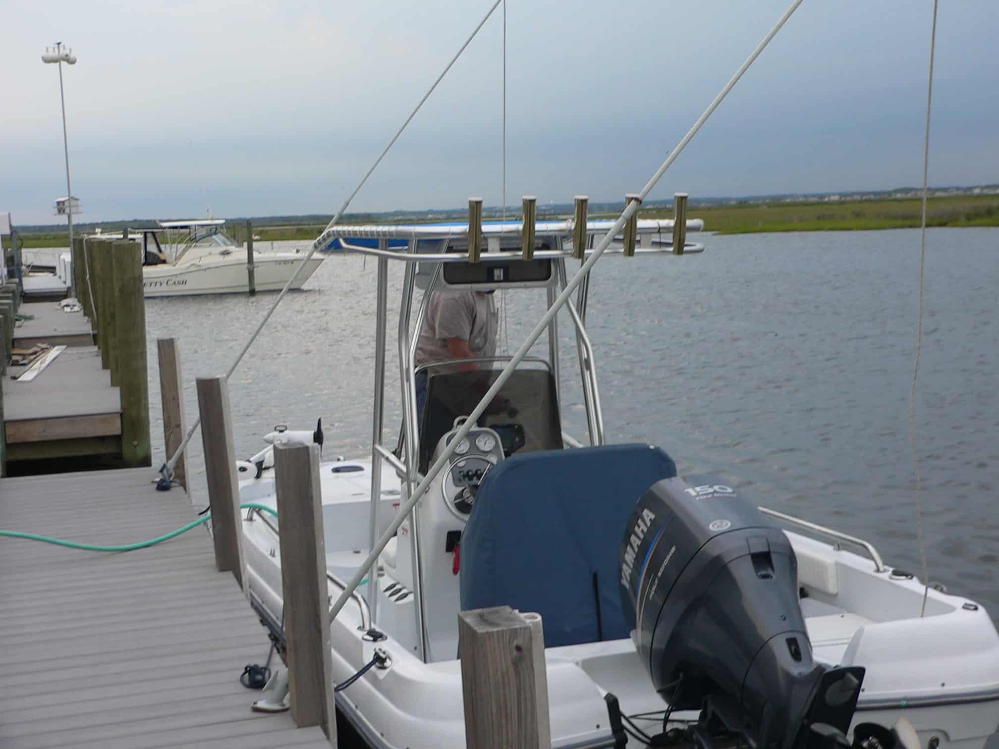 Atlantic Towers T-Top installed on a Triumph 190 Bay boat at the dock with water in the background.